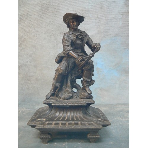 148 - A SPELTER FIGURE OF A MAN SHARPENING A SCYTHE - 29CM H