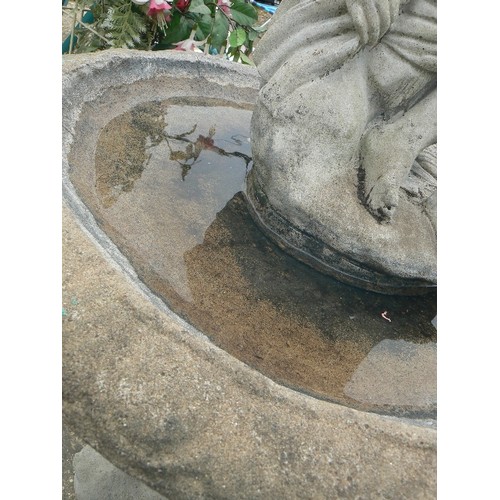 411 - LARGE SIMULATED STONE BIRD BATH ON STAND IN THE CLASSICAL STYLE WITH A NUDE FIGURE AT THE TOP