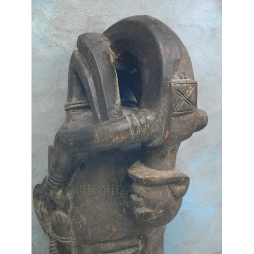 235 - AN AFRICAN CARVED MASK WITH A CROUCHING FIGURE FORMING THE HEADDRESS - PROBABLY FIRST HALF 20TH CENT... 