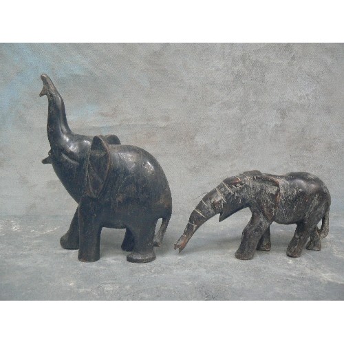 236 - FOUR VINTAGE CARVED ELEPHANT FIGURES INCLUDING AN ADULT AND BABY PULLING / PUSHING A LOG