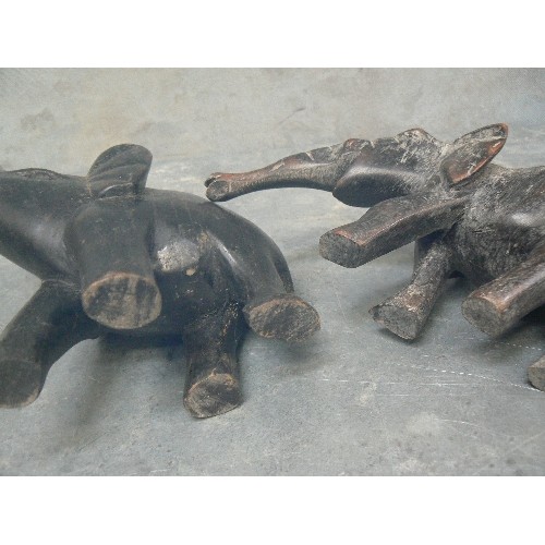 236 - FOUR VINTAGE CARVED ELEPHANT FIGURES INCLUDING AN ADULT AND BABY PULLING / PUSHING A LOG