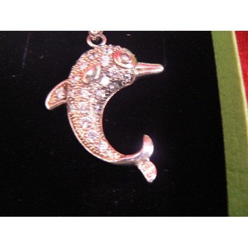 115 - A HEAVY SOLID SILVER DOLPHIN PENDANT ADORNED WITH WHITE STONES ON A SILVER 20