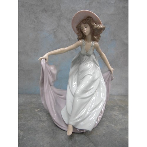 199H - A LLADRO PORCELAIN FIGURE OF A LADY DANCING WEARING A PINK HAT - 23CM H