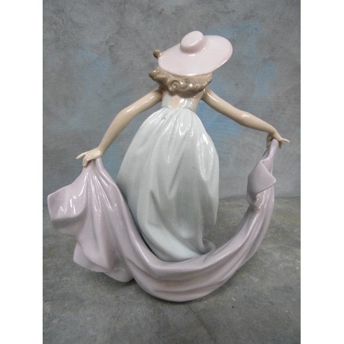 199H - A LLADRO PORCELAIN FIGURE OF A LADY DANCING WEARING A PINK HAT - 23CM H