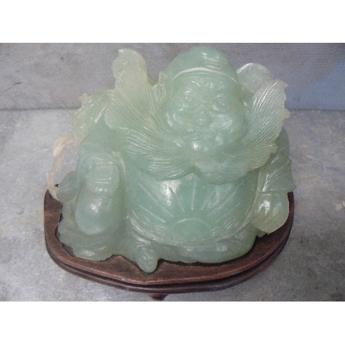 203A - LARGE CHINESE CARVED JADE IMMORTAL FIGURE WITH FLOWING BEARD AND SUNBURST CARVING TO BELLY - ON A WO... 