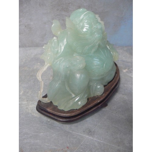 203A - LARGE CHINESE CARVED JADE IMMORTAL FIGURE WITH FLOWING BEARD AND SUNBURST CARVING TO BELLY - ON A WO... 