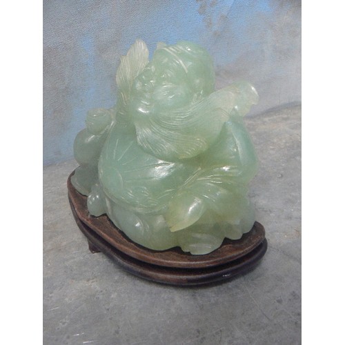 203A - LARGE CHINESE CARVED JADE IMMORTAL FIGURE WITH FLOWING BEARD AND SUNBURST CARVING TO BELLY - ON A WO... 