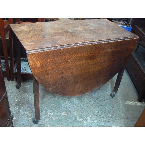 397 - GEORGIAN OAK DROP LEAF DINING TABLE, OVAL SHAPE. WITH LATER CASTORS ADDED