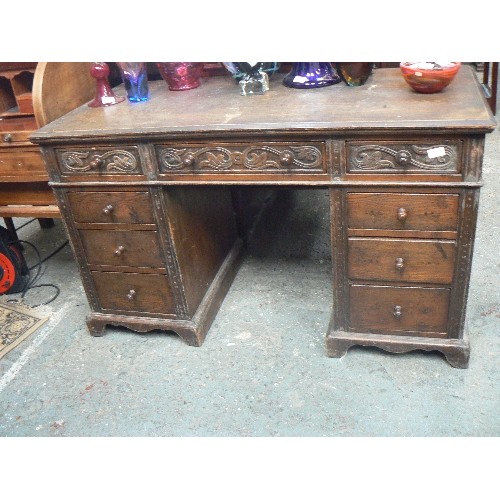 420 - EARLY 20TH CENTURY OAK PEDESTAL DESK WITH CARVING TO THE TOP DRAWERS