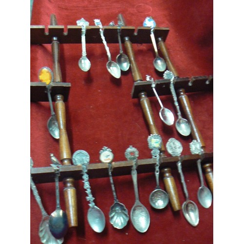 111 - LARGE COLLECTION OF SOUVENIR SPOONS DISPLAYED ON 2 WOODEN WALL RACKS.