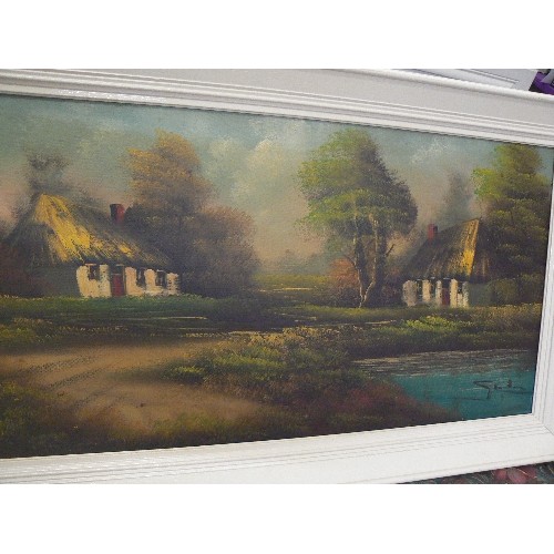 64 - VINTAGE OIL ON CANVAS. 2 THATCHED COTTAGES. PAINTED CREAM FRAME.