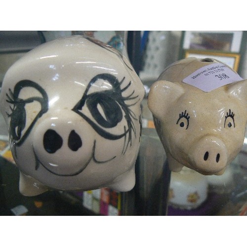 308 - 2 CERAMIC PIGGY BANKS. 'GIN MONEY' PIG AND A SMALLER PIG WHICH HAS SOME HAIRLINE CRACKS.