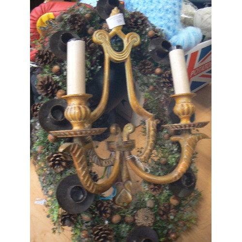 324 - CAST IRON CANDLE WALL SCONCE, ALSO IRON TABLE CENTRE WITH CANDLE HOLDERS AND FAUX GREENERY.