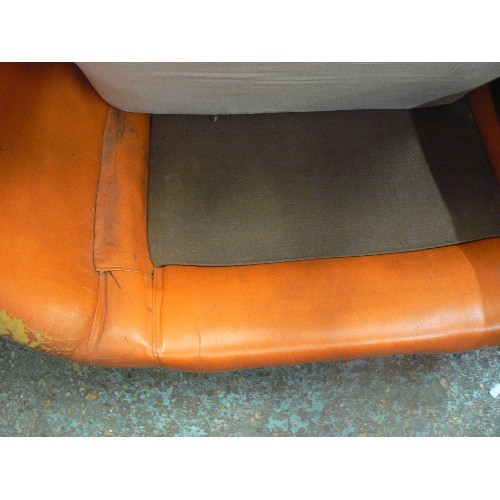 593 - VERY LARGE RETRO-VINTAGE ORANGE LEATHERETTE ARMCHAIR. CUSHIONS HAVE BEEN COVERED IN BROWN FLORAL FAB... 