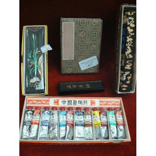 417 - SET OF CHINESE PAINT TUBES, BRUSH RESTS IN PRETTY BOXES, AND A SMALL PILLOW BOOK.