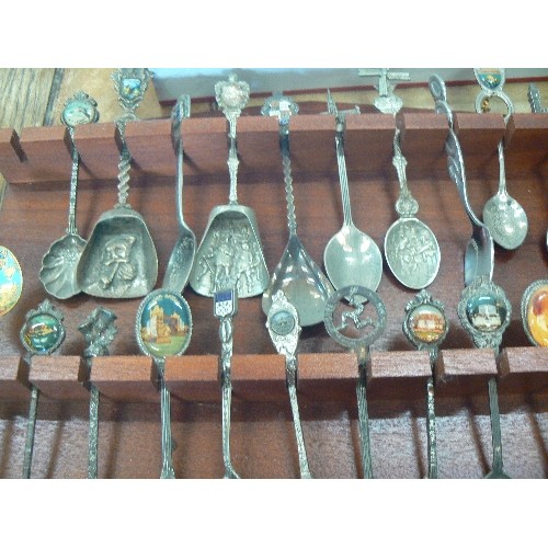 436 - APPROX 38 X COLLECTABLE SOUVENIR SPOONS. DISPLAYED ON A WALL RACK.