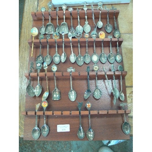 436 - APPROX 38 X COLLECTABLE SOUVENIR SPOONS. DISPLAYED ON A WALL RACK.