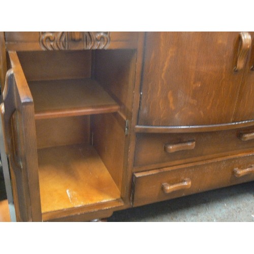 473 - HEAVY VINTAGE SIDEBOARD WITH CENTRAL BOW FRONTED DRINKS SECTION.