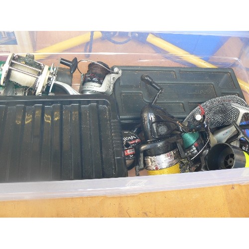 669 - LARGE STORAGE BOX FULL OF FISHING EQUIPMENT AND REELS.