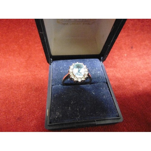 11 - SILVER 925 LADIES RING WITH LARGE LIGHT BLUE CENTRAL STONE SURROUNDED BY WHITE STONES