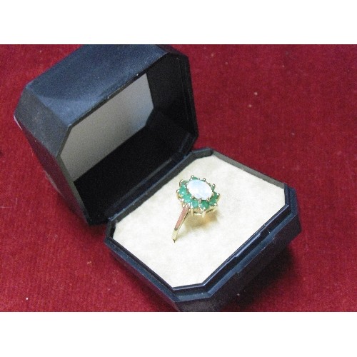 48 - A VINTAGE 9ct GOLD DRESS TO IMPRESS RING GOOD SIZE FIRE OPAL ( BLUE GREEN ORANGE) SURROUNDED BY GREE... 