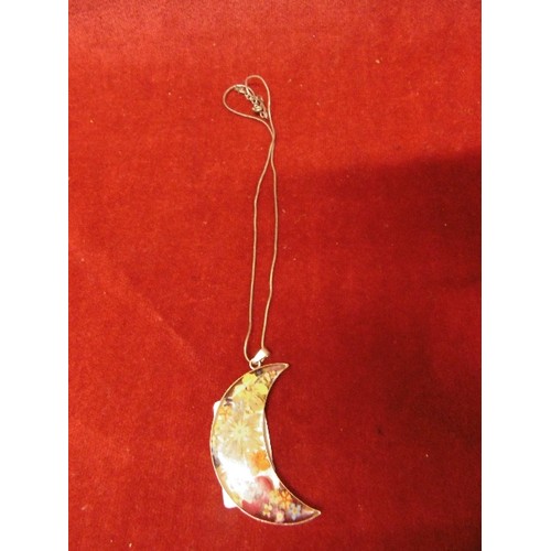 36 - A LARGE SILVER PENDANT OF FLOWERS SET IN RESIN IN THE SHAPE OF THE CRESCENT ON SILVER CHAIN