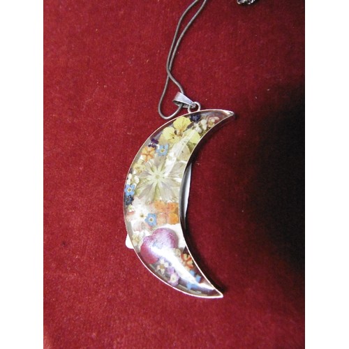 36 - A LARGE SILVER PENDANT OF FLOWERS SET IN RESIN IN THE SHAPE OF THE CRESCENT ON SILVER CHAIN