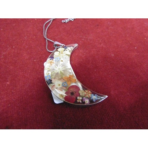 36 - A LARGE SILVER PENDANT OF FLOWERS SET IN RESIN IN THE SHAPE OF THE CRESCENT ON SILVER CHAIN