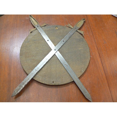 86 - EARLY 20TH CENTURY WALL MOUNTED BRASS SHIELD AND SWORD PLAQUE