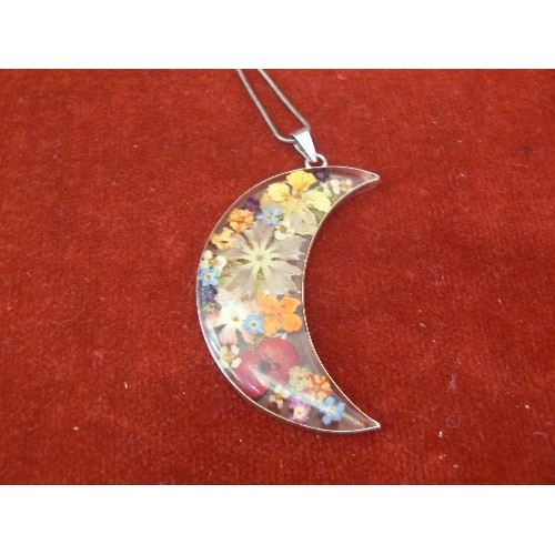 144 - A LARGE SILVER PENDANT OF FLOWERS SET IN RESIN IN THE SHAPE OF THE CRESCENT ON SILVER CHAIN