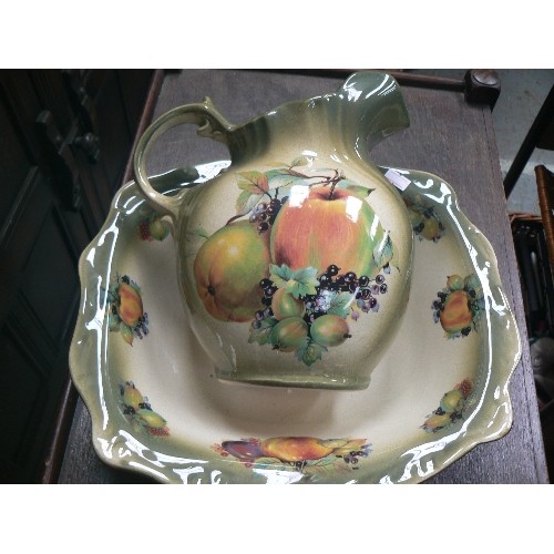 252 - JUG AND BOWL SET IN DARK GREEN WITH FRUIT DETAIL, AND A LARGE CREAM WASH JUG WITH PRETTY FLOWERS.