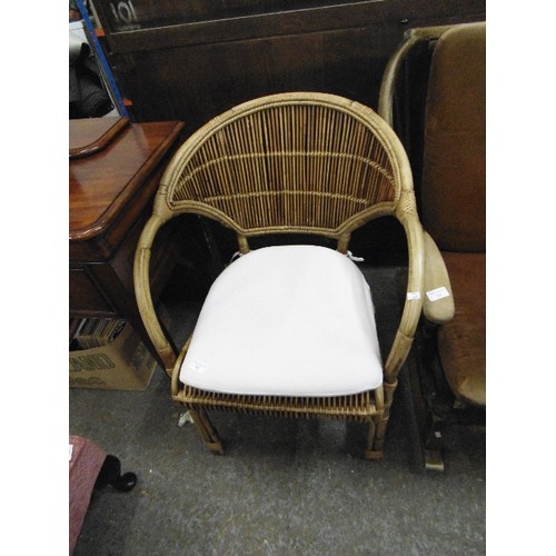 304 - CANE CONSERVATORY CHAIR WITH CREAM SEAT PAD.