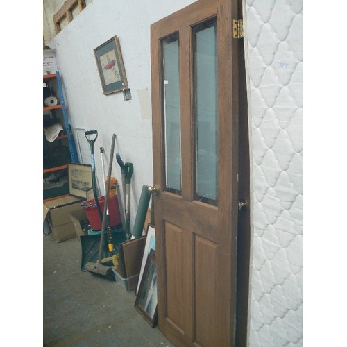 512 - PAIR OF 4-PANELLED WOODEN DOORS WITH GLAZING [PARTIALY OBSCURED] IN TOP PANELS. BRASS KNOBS.