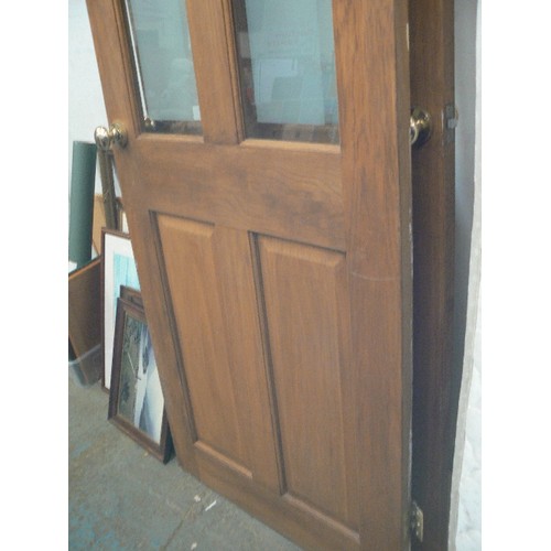 512 - PAIR OF 4-PANELLED WOODEN DOORS WITH GLAZING [PARTIALY OBSCURED] IN TOP PANELS. BRASS KNOBS.