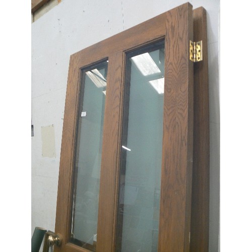 512 - PAIR OF 4-PANELLED WOODEN DOORS WITH GLAZING [PARTIALY OBSCURED] IN TOP PANELS. BRASS KNOBS.