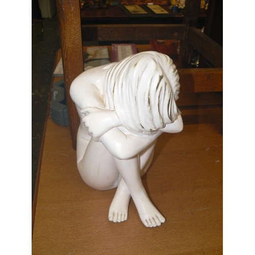 231 - LARGE KNEE HUGGING FIGURE, IN WHITE.