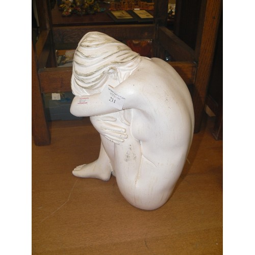 231 - LARGE KNEE HUGGING FIGURE, IN WHITE.