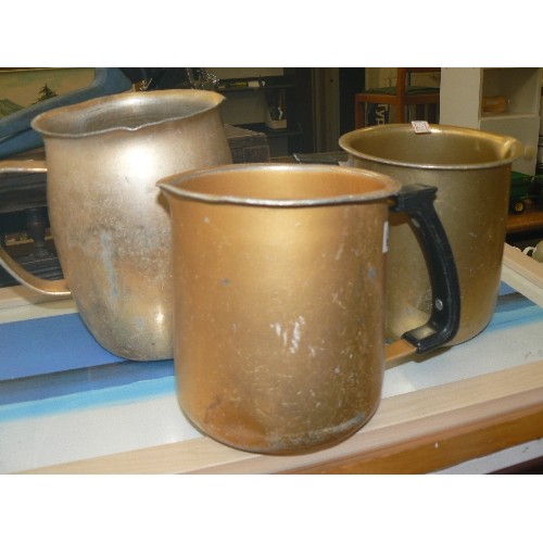 324 - 3 X GOLD COLOURED ALUMINIUM WATER JUGS.