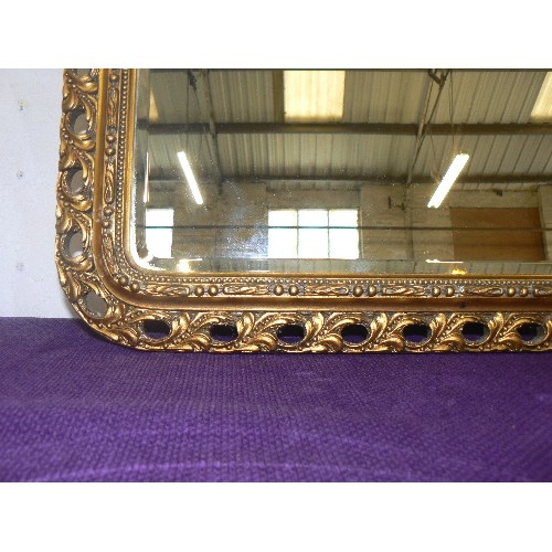 100 - GILT FRAMED WALL MIRROR WITH ARCHED TOP.