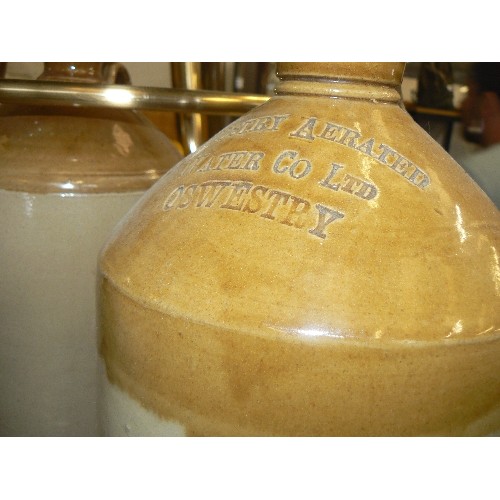 208 - 3 X STONEWARE FLAGONS. INCLUDES OSWESTRY AERATED WATER Co LTD. HANDLE IS CHIPPED, THE SMALLER ONE HA... 