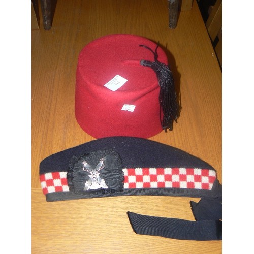 412 - EGYPTIAN FEZ IN RED AND A RED AND WHITE DICED GELNGARRY HAT WITH CAP BADGE