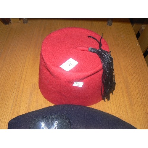 412 - EGYPTIAN FEZ IN RED AND A RED AND WHITE DICED GELNGARRY HAT WITH CAP BADGE