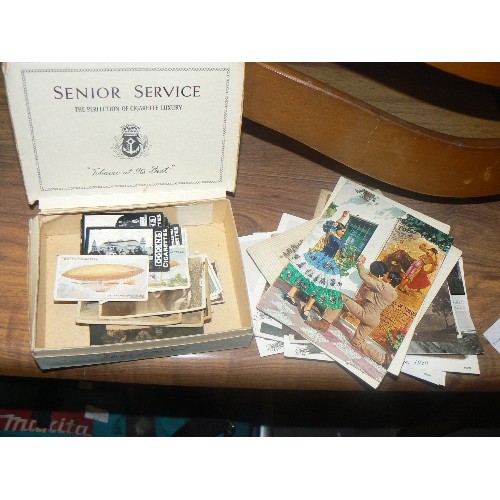 416 - COLLECTION OF VINTAGE AND NOVELTY POSTCARDS IN A SENOIR SERVICE CIGARETTE BOX AND OGDEN CIGARETTE CA... 