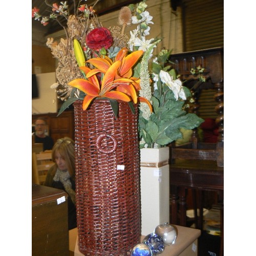 496 - QUANTITY OF SILK AND FAUX FLOWERS CONTAINED IN A TALL BASKET, AND A TALL VASE.