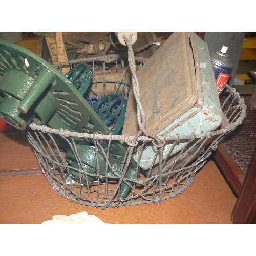 215 - CAST IRON TRIVET, EGG RACK, BOX OF DOUBLE-ENDED NAILS, ALL CONTAINED IN A VINTAGE WIRE BASKET.