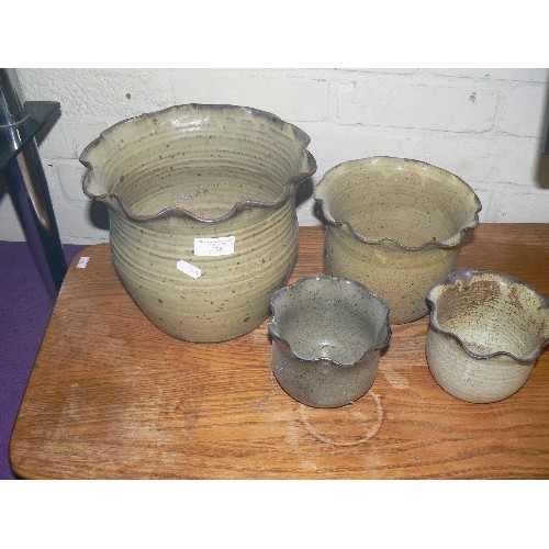 135 - SET OF 4 STONEWARE PLANTERS WITH FRILLED EDGE.