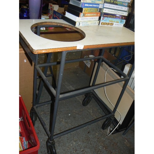 322 - WORKSHOP TROLLEY WITH LARGE CIRCULAR HOLE IN THE TOP. TUBULAR METAL FRAMEWORK. ON LARGE CASTORS.