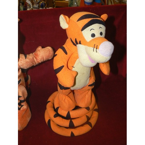 108 - 2 X VINTAGE TIGGERS. BOUNCING MECHANICAL TOYS. WE ARE TOLD THESE ARE WORKING.