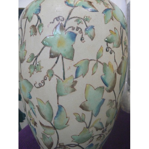 114 - LARGE CERAMIC VASE WITH IVY LEAF DESIGN ON SAND.