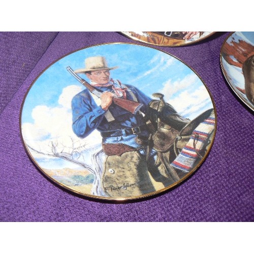 86 - 4 X JOHN WAYNE LIMITED EDITION COWBOY PLATES. FRANKLIN MINT. 1 HAS NIBBLE ON THE RIM.